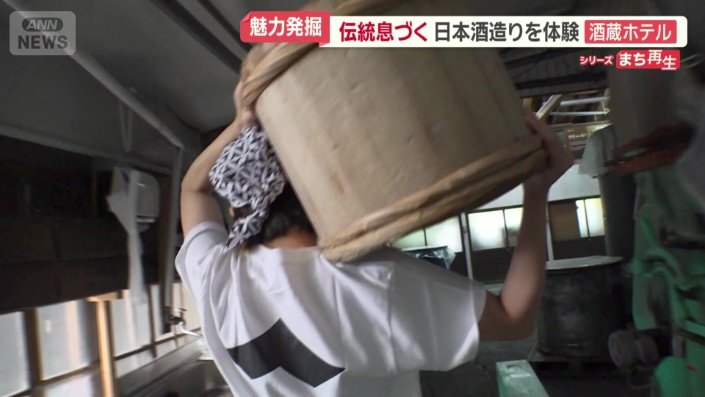 蒸したコメをたるで運ぶ