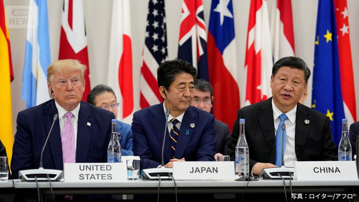 2019年6月28日、大阪で開催されたG20首脳会議での会合中、安倍晋三首相を挟んで並ぶドナルド・トランプ米大統領と習近平中国国家主席。